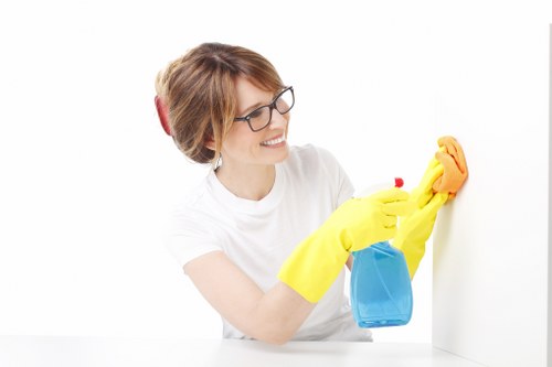 Technician performing commercial carpet cleaning in a workplace
